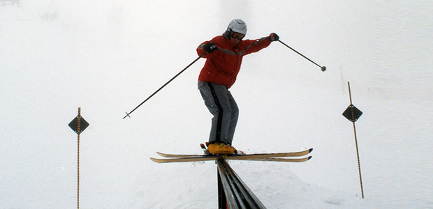 Freestyle skier sliding down a railing