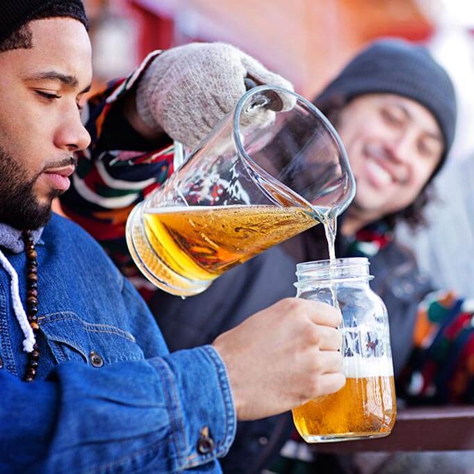 Après ski men sharing a pitcher of beer