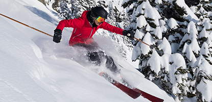 skier sliding down snowy mountain